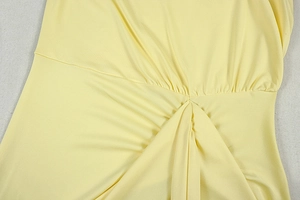 Close-up of gathered pleats and twisted fabric detail on a yellow summer A-line dress