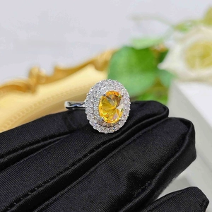 Macro detail of oval yellow zircon ring with double halo pavé setting in S925 silver