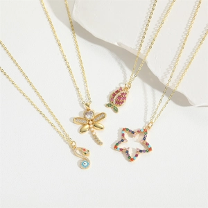 French vintage gold necklaces featuring dragonfly, heart, and star pendants with colorful zircons