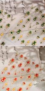 Close-up of vintage royal style nail stickers with gold emerald and ruby gemstone patterns