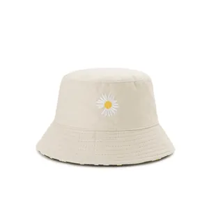 Detailed view of daisy embroidery on a beige cotton canvas sun hat for women and men