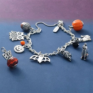Detail of Halloween beaded bracelet with silver owl, pumpkin, and BOO pendants