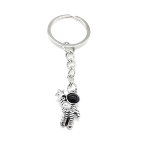 Retro astronaut keychain with a silver space traveler pendant on a white background