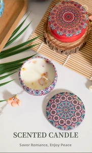 Macro shot of mandala tin scented candles with dried flowers on a rustic wooden stand