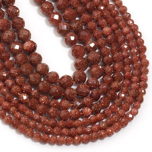 Macro shot of brown faceted natural stone beads with sparkling aventurine effect for DIY jewelry
