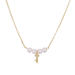 Golden pearl necklace featuring a heart-shaped key pendant with sparkling accents