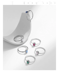 Macro shot of 925 silver rings with colorful oval gemstones and sparkling halo settings