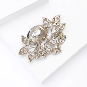 Detailed back view of a silver leaf brooch showing the metal texture and pin fastening