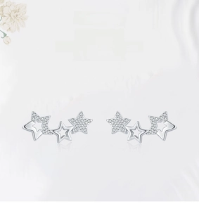 Macro shot of minimalist 925 sterling silver star earrings showing premium texture