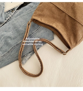 Detail view of brown corduroy tote bag featuring a functional adjustable shoulder strap
