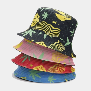 Close-up of four reversible bucket hats featuring street-style smiley and leaf prints