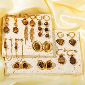 Golden earring set with natural tiger eye stones featuring heart and fringe designs