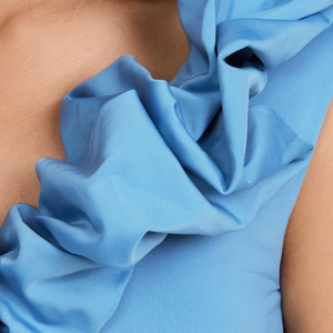 Detail of sky blue swimwear featuring textured ruffles and high-quality pleated fabric