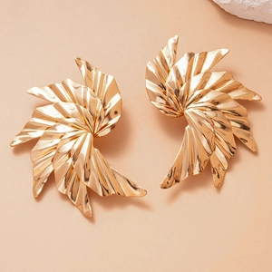 Detailed view of glossy gold-finish metal earrings in a ruffled fan-shaped wing design