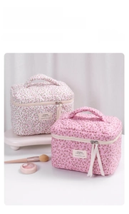 Detail of floral quilted cotton makeup bags with elegant ribbon zipper and sturdy handle