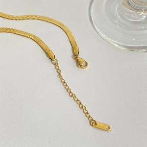 Close-up of 18k gold plated snake chain necklace with K18 tag and lobster clasp