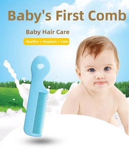 Close-up of baby hairbrush with rounded teeth and heart-shaped handle for infant care