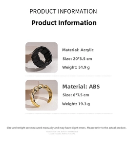 Detail view of twisted gold ABS cuff and black acrylic geometric bracelet with specs