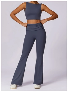 Detail of high-waist flared yoga pants and racerback crop top in dark grey blue
