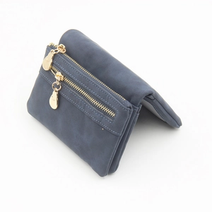 Close-up of matte grey leather wallet featuring dual gold zippers and water-drop charms