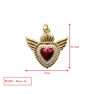 Golden winged heart pendant with red stone and clear gems showing 25.5mm x 21mm size details
