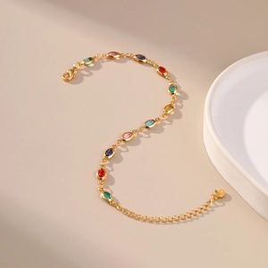 Exotic 18K gold plated bracelet featuring colorful oval acrylic stones on beige background