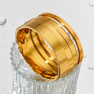 Summer gold-plated stainless steel wide cuff bracelet with a multi-layered polished design