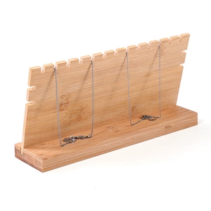 Pink solid wood necklace display stand with multiple slots for jewelry storage