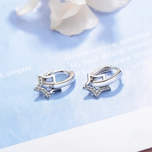 Elegant silver star hoop earrings with shimmering rhinestones on light blue background