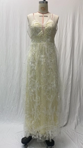 Close-up of V-neck lace wedding dress featuring delicate white floral embroidery and sequins