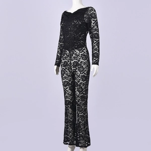 Detail of floral lace texture on long sleeve jumpsuit showing intricate black patterns