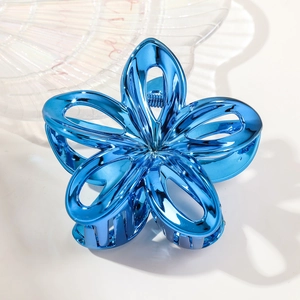 Detailed top view of a blue hollow frangipani flower hair claw with a metallic finish