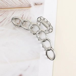 Detail of silver chain-style metal hair claw clip with modern elegant aesthetic