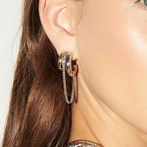 Detail shot of mixed gold and silver ring earrings with long metal chain fringe