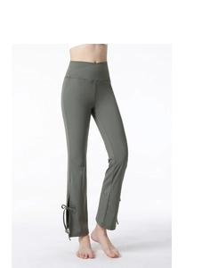 Detail of crossover high waist yoga pants with bow-tie split hem in dark olive green