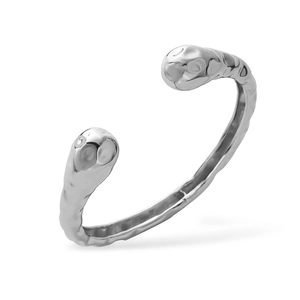 Macro view of silver open cuff bracelet featuring unique irregular hammered texture