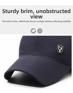 Close-up of a navy baseball cap with a reinforced brim and shield metal logo detail