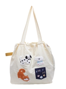Cream canvas tote bag with puppy cat embroidery and drawstring closure on white background