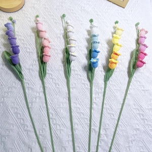 Handmade crochet lily of the valley bouquet in six vibrant colors on white fabric