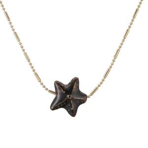 Natural ceramic starfish pendant necklace with gold beaded chain on white background