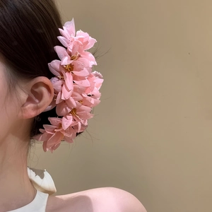 Detailed view of a sweet pink fabric flower hair pin, perfect for elegant Hanfu styling.