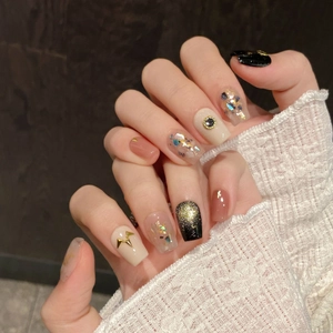 Vintage style handmade press-on nails with shell fragments, cat eye effects, and gold accents