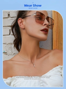 Detail shot of a model wearing a 925 sterling silver mini airplane pendant necklace
