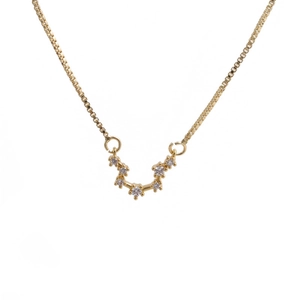Detailed close-up of golden box chain with sparkling cubic zirconia zodiac constellation pendant