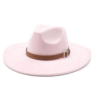 Detail of light pink wide brim fedora hat featuring a braided brown leather decorative band