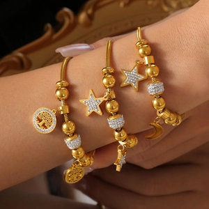 Gold plated tree of life star and moon charm bracelet with crystals on wrist