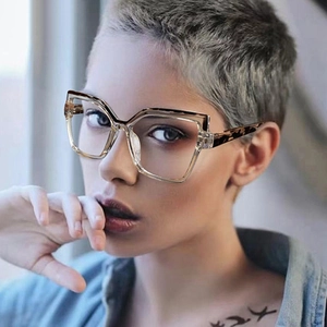 Close-up of geometric cat-eye glasses frame with tortoiseshell and transparent details