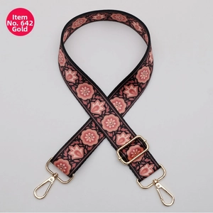 Close-up of ethnic pink floral pattern bag strap with adjustable gold swivel metal hook