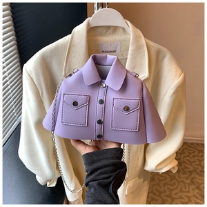 Detail of creative purple jacket-shaped crossbody bag with silver buttons and chain