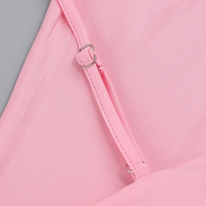 Detailed close-up of adjustable silver buckles and pink ribbed knit fabric shoulder straps